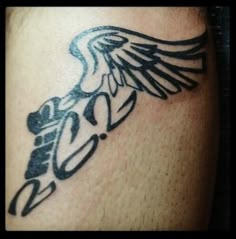 a black and white tattoo on the leg of a man with an eagle in it