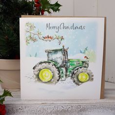 a christmas card with a green tractor on the front and merry christmas written in yellow