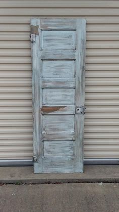 an old wooden door sitting on the side of a building