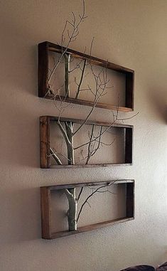 two wooden shelves with branches in them on the wall