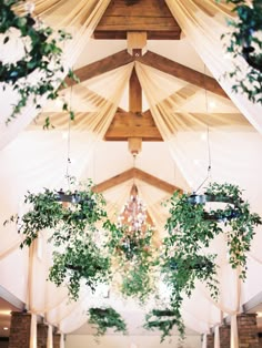 the inside of a church decorated with greenery