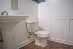 a white toilet sitting in a bathroom next to a sink