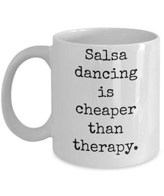 a white coffee mug that says salsa dancing is cheaper than therapy on the inside