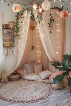 a room with lights and plants on the ceiling, hanging from the ceiling over a bed