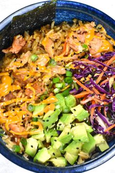 a blue bowl filled with different types of food