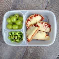 a plastic container filled with food on top of a wooden table