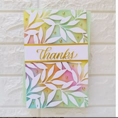 a handmade thank card with leaves on it and the words thanks written in gold