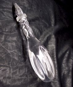 a glass spoon sitting on top of a black cloth