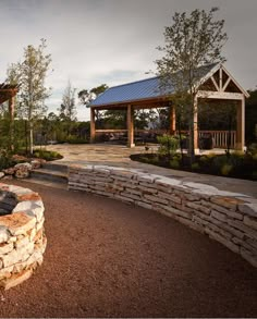 a stone fire pit surrounded by trees and rocks