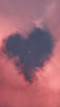 a heart shaped cloud in the sky with a moon and stars on it's side