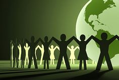 a group of people holding hands in front of a green globe with the earth on it