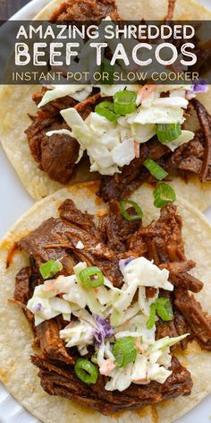 two beef tacos sitting on top of a white plate