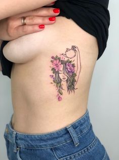 a woman's lower back tattoo with flowers on her stomach and the bottom part of her body