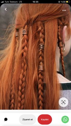 an orange haired woman with long braids on her head