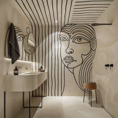 a bathroom with a drawing on the wall next to a sink