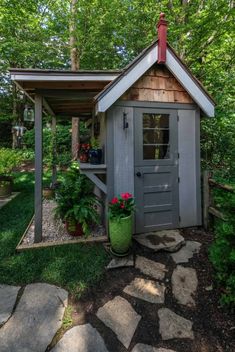 a small shed in the middle of a garden