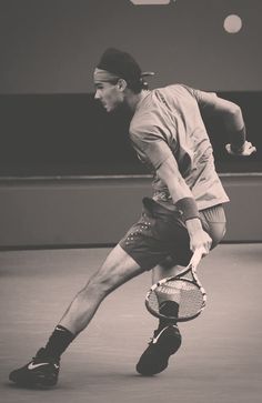 a man holding a tennis racquet on top of a tennis court