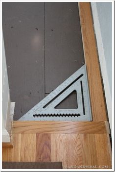 the door is being installed with a square and triangle ruler on it's side