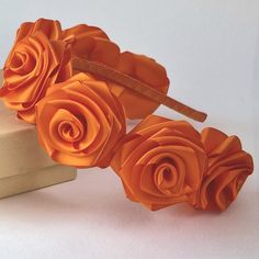 This orange   floral hairband is hand decorated with 7 orange  satin roses.The diameter of the flower is approximately   5cm.The metallic headband is  covered with orange satin ribbon,it is comfortable and adjust to fit most head sizes,from very young children to adults.Perfect for flower girls,bridesmaids or special occasions.    I make to order. Production time is 1-3 days. It is 100% handmade. Thick Orange Headband, Metallic Headband, Floral Hairband, Orange Satin, Band Hair, Satin Roses, Orange Roses, Head Band, Turbans