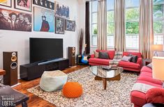 a living room filled with furniture and a flat screen tv mounted to the side of a wall