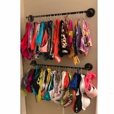 a rack with several pairs of shoes and bras hanging from it's sides