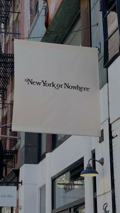 a sign hanging from the side of a building that says new york and nowhere on it