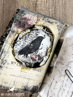 an altered book with a black bird on it