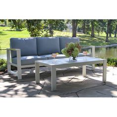 a couch and table sitting on top of a patio