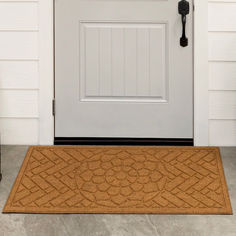 a door mat on the side of a white front door with a black phone next to it