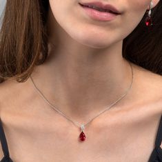 Features * Stylish Red necklace with a teardrop pendant on a stone-studded bail with an adjustable 18" chain, including 2-inch extension links. * 925 Sterling silver pendant necklace for women with a 8mm by 21 mm ruby red pendant. Stylish stone necklaces for women with 8mm by 12mm red pear-shaped stone with delicate    AAA cubic zirconia stones on the bail. * Solid silver chain and pendant. These elegant red necklaces for women are made from Rhodium plated 925 Sterling Silver. * High quality 925 Red Silver Jewelry, Simple Ruby Necklace Designs, Elegant Red Necklace, Red Diamond Necklace, Ruby Stone Necklace, Red Necklaces, Ruby Necklace Designs, Ruby Pendant Necklace, Red Pendant Necklace