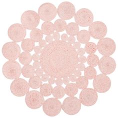 a pink rug with circles in the middle on a white background, it is made up of