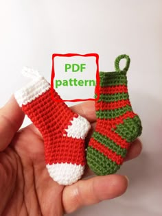 a crocheted christmas stocking and sock ornament being held by someone's hand