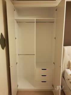 an empty white closet with two drawers