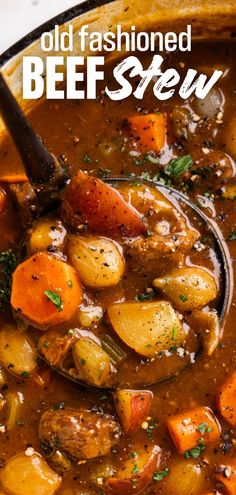 a close up of a bowl of stew with carrots and potatoes on the side