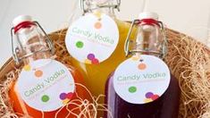 three bottles of candy vodka sitting in a basket