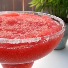 a bowl filled with red liquid next to a potted plant and text that reads 6 ounces tequila triple sec