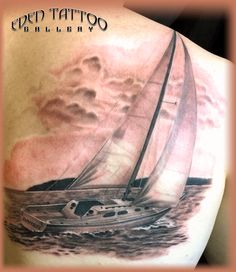 a man with a sailboat tattoo on his back