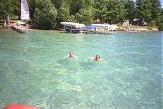 two people swimming in the clear blue water