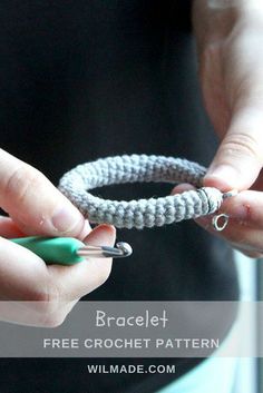 a woman is holding a crochet bracelet with two green beads on it and the text, braclet free crochet pattern