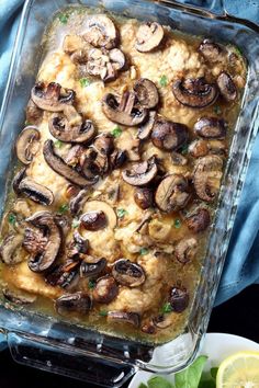 a casserole dish filled with mashed potatoes, mushrooms and garnishes