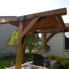 a wooden pergoline covered patio in front of a house with an award for customer photo