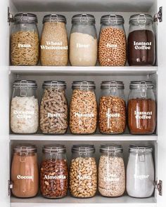 an organized pantry filled with lots of different types of food and drinks in glass jars