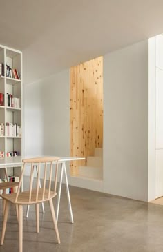 an empty room with bookshelves and chairs in it