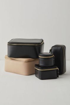 three pieces of black and tan leather with zippers on the sides, one is empty