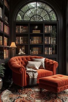 an orange chair and ottoman in front of a bookshelf