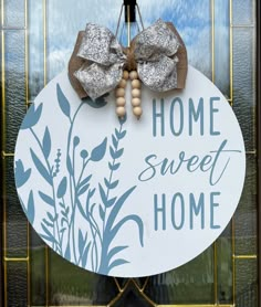 a home sweet sign hanging on the front door