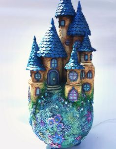 a ceramic vase with some houses painted on it