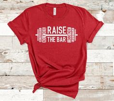 RAISE THE BAR! This super soft t-shirt is perfect for your next workout, or even your rest day! *I will use either black or white for the text depending on the shirt color you choose. If you have a preference please let me know in the notes section. *COLORS: Colors may vary slightly from as they appear on your monitor. These tees are all heathered tees. I choose them because they are the softest possible and they feel amazing! If you're looking for a more solid/primary color not shown, feel free Powerlifting Shirt Ideas, Workout Tshirts Women Graphic Tees, Crossfit Shirts For Women, Powerlifting Shirts Design, Fitness T Shirts Design, Crossfit Shirts Design, Gym Shirts For Women, Powerlifting Shirts, Crossfit Tshirts