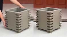 two cement planters sitting next to each other