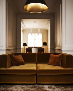 a living room with two couches and a table in the corner, along with lamps on either side